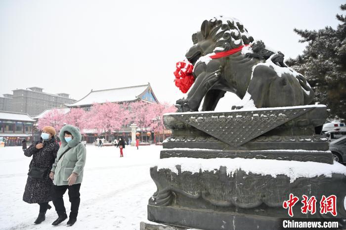 2月13日，民眾在呼和浩特市大召廣場(chǎng)雪中漫步?！⑽娜A 攝