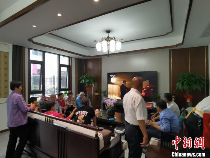 親友們集中在費(fèi)俊龍家中觀看返程的視頻?！＄娚?攝