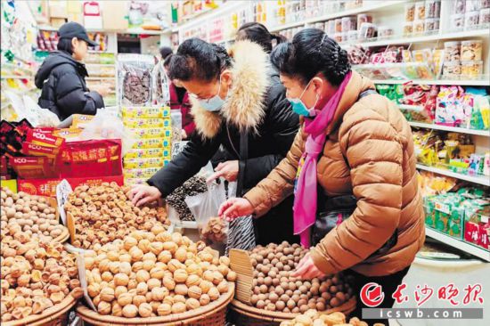 　　在長沙南門口菜市場附近的一家炒貨店內(nèi)，市民正在選購年貨。　　長沙晚報全媒體記者 范宏歡 攝