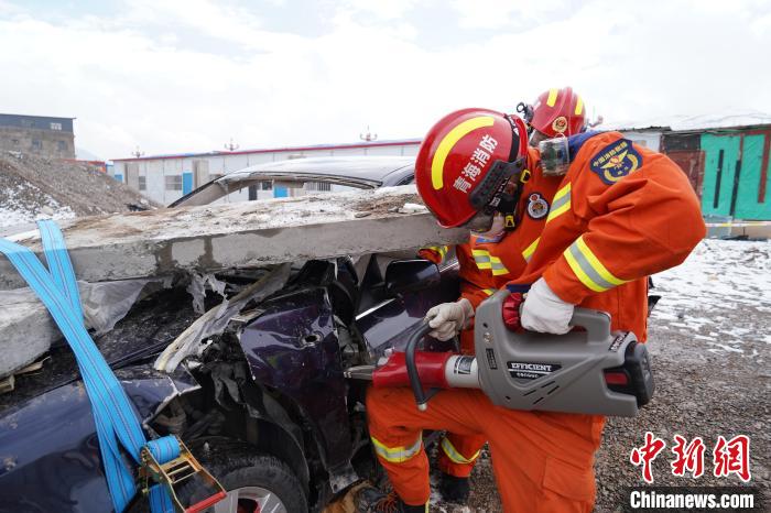 圖為地震實戰(zhàn)拉動現(xiàn)場，參演人員進行車輛破拆?！∮駱湎拦﹫D