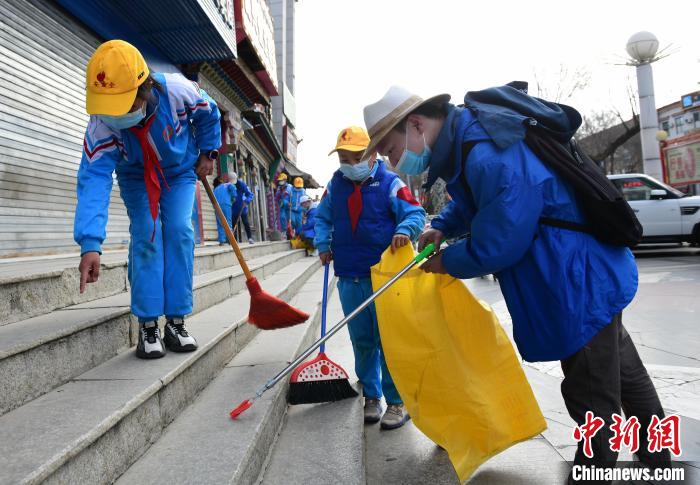 圖為拉薩市小學生打掃街道?！∝暩聛硭?攝