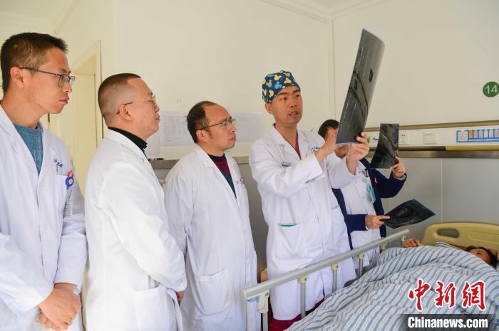 圖為醫(yī)療援藏專家何蔚(站右二)與馮敬云(左二)、廖濤(左三)等人討論患者病情。(資料圖) 貢嘎來松 攝