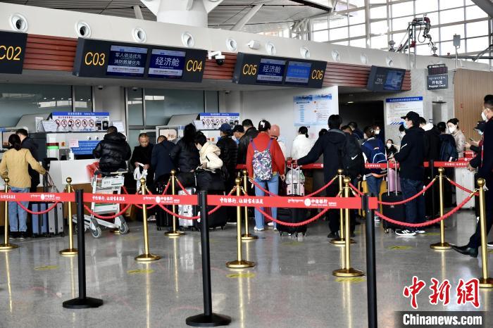 圖為旅客辦理登機(jī)手續(xù)?！≈芎?攝